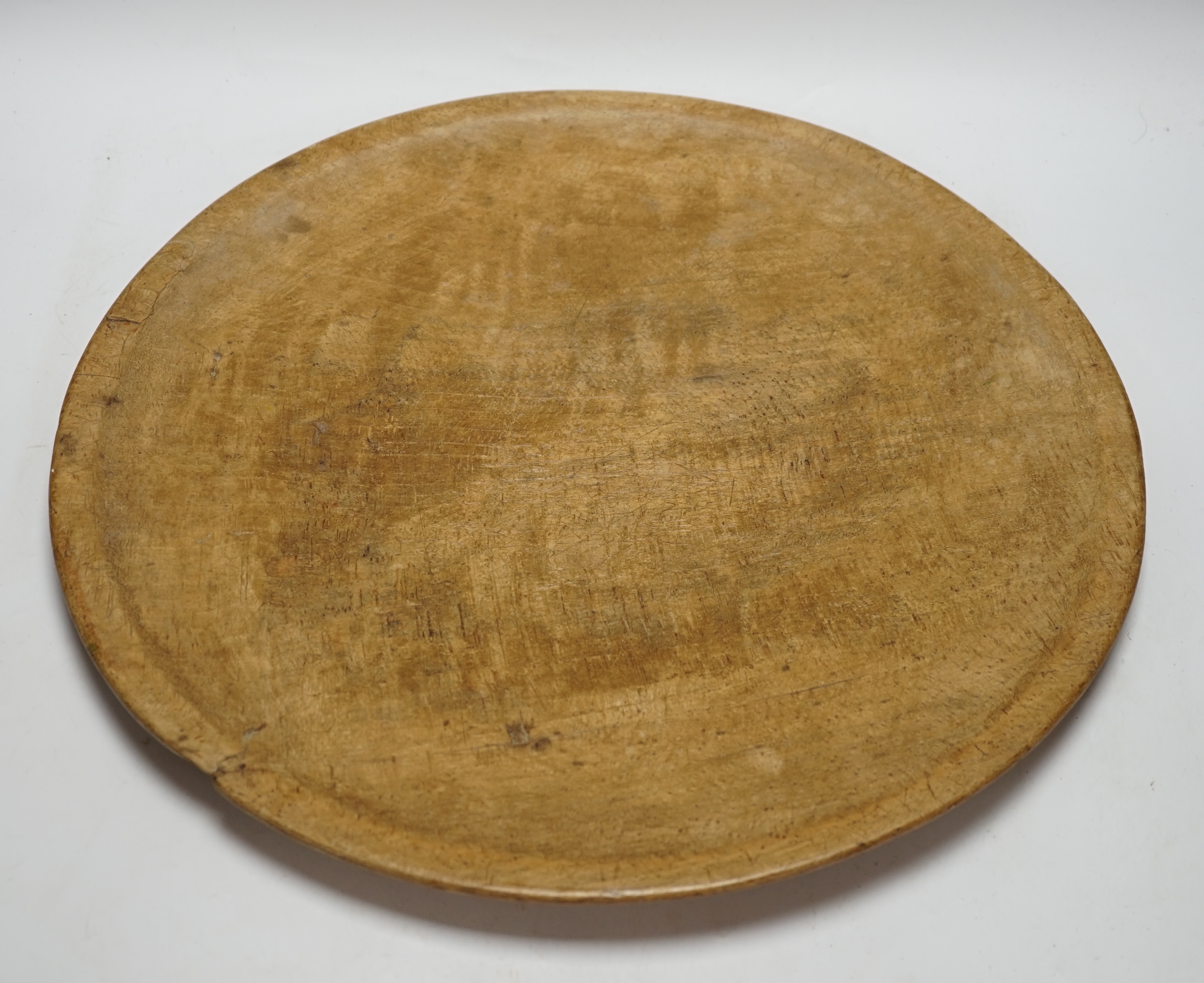 A large turned beech bowl of shallow form, 45cm in diameter